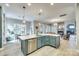 Open-concept kitchen flows into the living area, featuring a large island and stainless steel appliances at 349 Miners Cove Way, Fort Mill, SC 29708