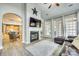 Bright living room with fireplace, large windows, and open access to the kitchen at 349 Miners Cove Way, Fort Mill, SC 29708