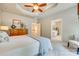 Comfortable main bedroom with ceiling fan, dresser and access to ensuite bathroom at 349 Miners Cove Way, Fort Mill, SC 29708