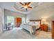 Spacious main bedroom with a tray ceiling, ceiling fan, and large windows at 349 Miners Cove Way, Fort Mill, SC 29708