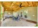 Inviting covered patio with dining and seating areas, ceiling fans, and natural wood accents at 349 Miners Cove Way, Fort Mill, SC 29708