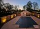 Backyard at dusk featuring a covered swimming pool, fenced yard, and string lights at 3755 11Th Ne St, Hickory, NC 28601