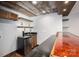 Bar area with mini fridge, granite countertop, and custom shelving at 3755 11Th Ne St, Hickory, NC 28601