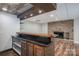 Basement bar area featuring granite countertops and a stone fireplace at 3755 11Th Ne St, Hickory, NC 28601