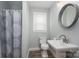 Bathroom featuring sleek pedestal sink, patterned shower curtain, and brushed fixtures at 3755 11Th Ne St, Hickory, NC 28601