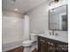 Modern bathroom featuring marble vanity, tub-shower combo, and contemporary fixtures at 3755 11Th Ne St, Hickory, NC 28601