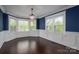 Formal dining room featuring bay windows and an elegant chandelier with dark hardwood floors at 3755 11Th Ne St, Hickory, NC 28601