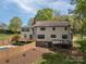 Back of a two-story home with a deck, fenced yard, and partial pool view at 3755 11Th Ne St, Hickory, NC 28601