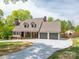 Inviting home featuring a brick-accented porch, two-car garage, and long driveway at 3755 11Th Ne St, Hickory, NC 28601