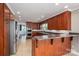 Updated eat-in kitchen with wood cabinets, stainless steel appliances, a breakfast bar and a view into the entry at 3755 11Th Ne St, Hickory, NC 28601
