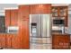 Cherry wood kitchen featuring stainless steel appliances, wood cabinets, granite countertops and a tile backsplash at 3755 11Th Ne St, Hickory, NC 28601