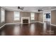 Spacious living room with a cozy fireplace, hardwood floors, and neutral wall paint at 3755 11Th Ne St, Hickory, NC 28601