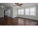 Large main bedroom with dark hardwood floors, three large windows, and an ensuite bathroom at 3755 11Th Ne St, Hickory, NC 28601