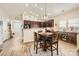 A view of the dining area with wood floors, stainless appliances, and custom cabinetry at 3939 Archer Notch Ln, Huntersville, NC 28078