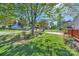 Well-manicured front yard featuring lush green grass, garden beds, and mature trees at 3939 Archer Notch Ln, Huntersville, NC 28078