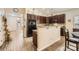 Modern kitchen featuring dark wood cabinetry and granite countertops, with an open layout to the entryway at 3939 Archer Notch Ln, Huntersville, NC 28078