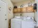 Functional laundry room with a washer and dryer and a cabinet with a clock at 3939 Archer Notch Ln, Huntersville, NC 28078