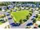 Aerial view of a planned community showcasing well-manicured lawns and sidewalks and tree-lined streets at 4083 Home Grown Way, Clover, SC 29710