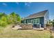 Well-maintained backyard featuring a brick patio, outdoor grill area, and mature trees for added privacy at 4083 Home Grown Way, Clover, SC 29710