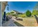 Landscaped backyard featuring a brick patio with outdoor dining and a charming swing set at 4083 Home Grown Way, Clover, SC 29710