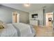 Neutral bedroom featuring a dresser, TV, and doorways leading to other rooms at 4083 Home Grown Way, Clover, SC 29710