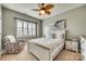 Cozy bedroom with a ceiling fan, large window, and a comfortable chair at 4083 Home Grown Way, Clover, SC 29710
