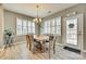 Cozy dining room with a wood table, comfortable chairs, plantation shutters, and a modern light fixture at 4083 Home Grown Way, Clover, SC 29710