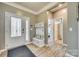 Inviting foyer with wood floors, coat rack and storage, and front door with decorative glass at 4083 Home Grown Way, Clover, SC 29710
