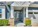 Covered front porch with stone accents and attractive curb appeal at 4083 Home Grown Way, Clover, SC 29710