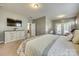 Spacious main bedroom featuring a large bed, stylish furniture, and a view of the private balcony at 4083 Home Grown Way, Clover, SC 29710