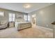 Serene main bedroom featuring plush carpet, plantation shutters, and a view of the ensuite bathroom at 4083 Home Grown Way, Clover, SC 29710