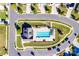 Aerial view of a community pool with a lounge area surrounded by green landscaping and neighborhood streets at 4083 Home Grown Way, Clover, SC 29710