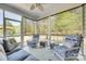 Inviting screened porch featuring stylish seating and a tranquil view of the backyard and landscaping at 4083 Home Grown Way, Clover, SC 29710