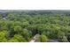 An aerial perspective of a house surrounded by dense green forest at 409 Woodcrest Ln, Albemarle, NC 28001