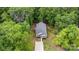 Aerial view of a quaint home nestled amidst lush green trees at 409 Woodcrest Ln, Albemarle, NC 28001