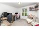 Bright bedroom space featuring a large window, gaming setup, comfortable seating area, and neutral carpet flooring at 409 Woodcrest Ln, Albemarle, NC 28001