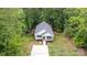 Charming exterior view of a home with a gray roof, white siding, an inviting front porch, and a long drive at 409 Woodcrest Ln, Albemarle, NC 28001