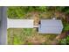 An aerial view showing the house's roof, driveway, deck, and surrounding landscape at 409 Woodcrest Ln, Albemarle, NC 28001