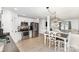 Open kitchen with stainless appliances, an eat-in area and white cabinetry at 409 Woodcrest Ln, Albemarle, NC 28001