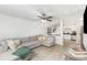 Open living room with a gray sectional sofa and a glimpse into the bright kitchen at 409 Woodcrest Ln, Albemarle, NC 28001