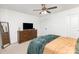 This carpeted main bedroom has a dresser with a TV and a side table at 409 Woodcrest Ln, Albemarle, NC 28001