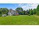 Aerial view of large home with deck, shed, and expansive green lawn at 426 Walden Trl, Waxhaw, NC 28173