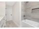 A bathtub and frameless glass shower are the focal points of this modern bathroom at 426 Walden Trl, Waxhaw, NC 28173
