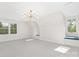 Bright bonus room with natural light, neutral colors, and modern chandelier at 426 Walden Trl, Waxhaw, NC 28173