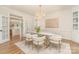 Bright dining room featuring a glass table, modern chairs, and elegant chandelier at 426 Walden Trl, Waxhaw, NC 28173
