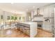 Modern kitchen with a large island, stainless steel appliances, and hardwood floors at 426 Walden Trl, Waxhaw, NC 28173