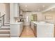 Bright, modern kitchen features stainless steel appliances, white cabinets, and an island with marble countertop at 426 Walden Trl, Waxhaw, NC 28173