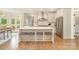 Bright kitchen featuring a large island with seating, stainless steel appliances, and wood floors at 426 Walden Trl, Waxhaw, NC 28173
