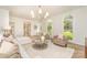 Open living room featuring hardwood floors, neutral furniture, and arched windows at 426 Walden Trl, Waxhaw, NC 28173