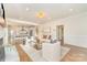 Open-concept living area with hardwood floors, fireplace, and seamless flow to the modern kitchen at 426 Walden Trl, Waxhaw, NC 28173